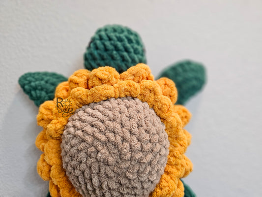 Sunflower, Closeup - Crochet sea turtle with a forest green body and golden yellow sunflower shell. The center of the sunflower is sandy brown. 