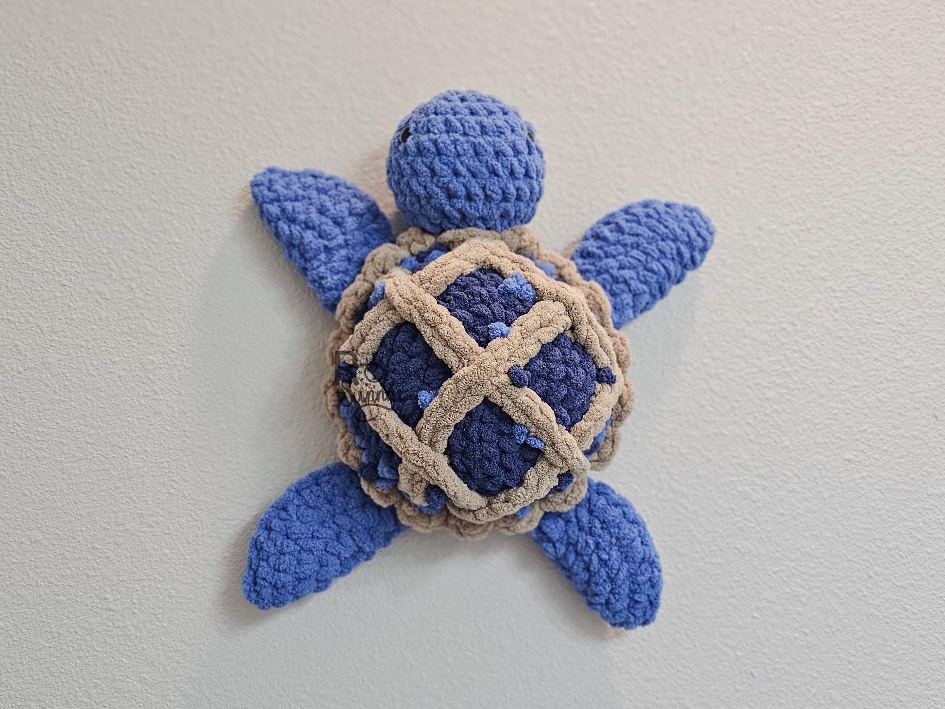 Blueberry Pie, Overhead, Lying Flat - Crochet sea turtle with a blue body and shell that looks like a lattice crusted blueberry pie.  Little blueberries are embroidered on the pie shell to add texture. 