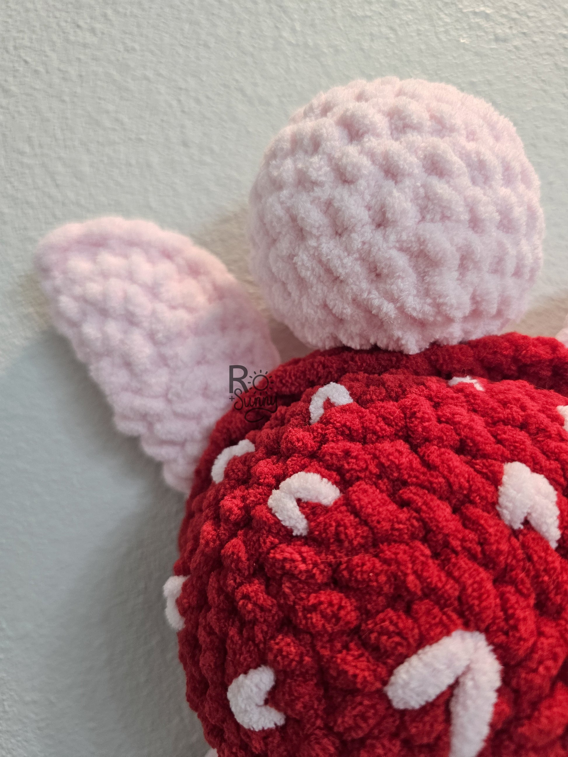 Sea of Love, Closeup - Crochet sea turtle with a light pink body and red shell with white hearts.