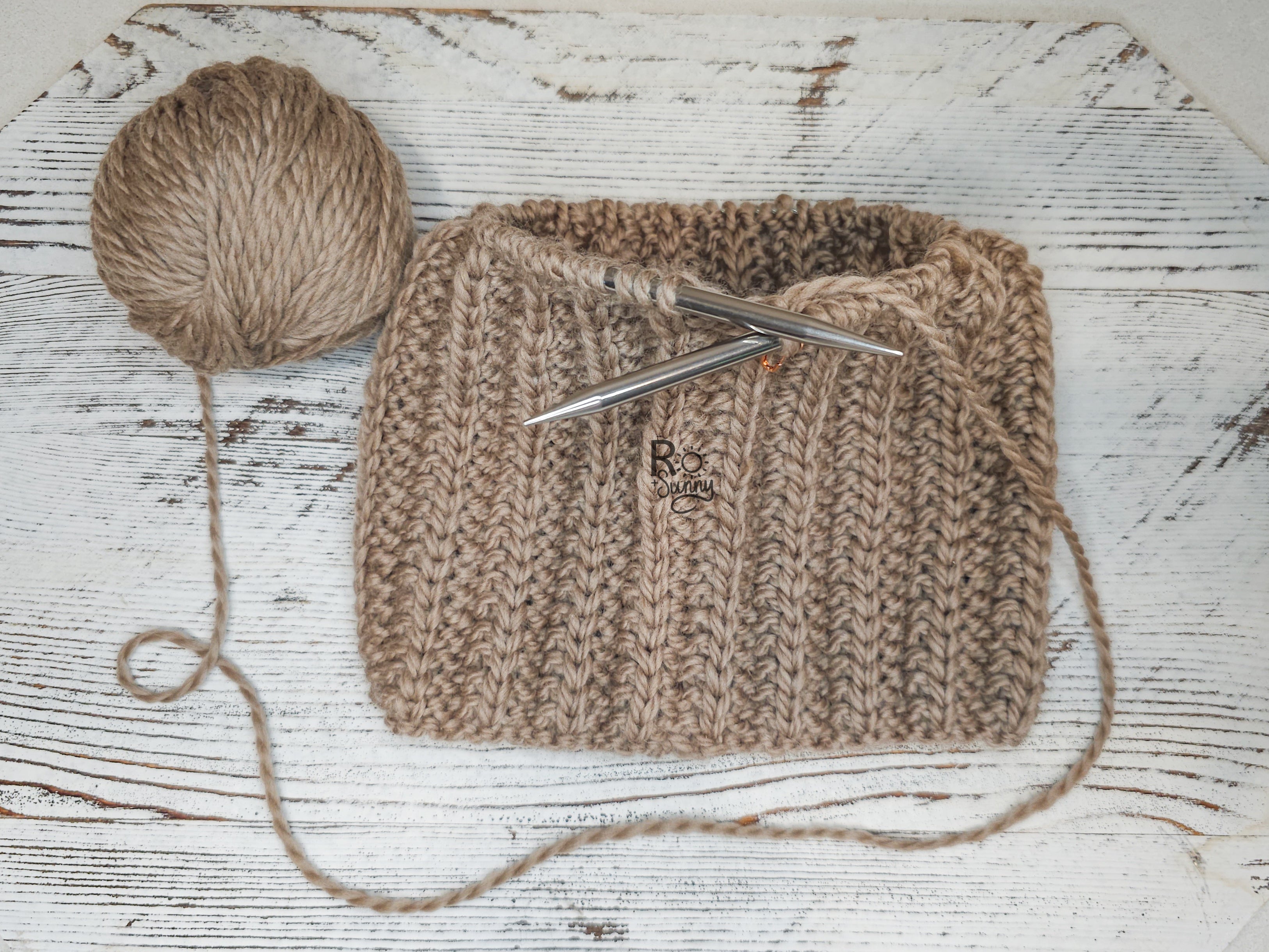 Overhead view of a handknit hat that is being worked on. 